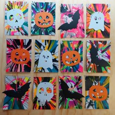 six halloween cards are arranged on a wooden surface, each with different designs and colors