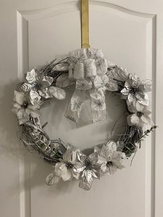 a white wreath hanging on the front door