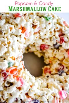 a close up of a cake with marshmallows on it and the words, popcorn & candy marshmallow cake