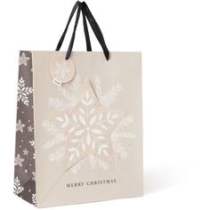 a christmas shopping bag with a snowflake design on the front, and a merry christmas tag hanging from it