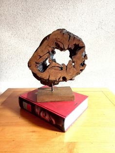 a book with a donut on top of it sitting on a table next to a stack of books