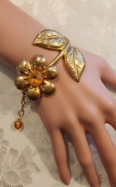 "I love this adorable bracelet! The stunning large centerpiece of this assemblage bracelet features a vintage brass 1960s-1970s figural topaz floral rhinestone brooch that has been combined with vintage Swarovski topaz crystal beads. The flower is 2\" wide t its widest points and the bracelet is 78\" to 8 1/4\" long.  It is so cute!   Our assemblage bracelets a great gift for Christmas, a birthday or an anniversary....or just buy it for yourself.   We have included free insured First Class shipp 1970s Jewelry, Topaz Crystal, Large Centerpiece, Jewelry Flower, Cute Bracelets, Vintage Jewels, Flower Bracelet, Rhinestone Brooches, Vintage Costume Jewelry