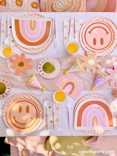 a table set up with plates, napkins and place settings for a children's birthday party