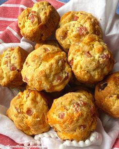 a pile of muffins sitting on top of a red and white towel