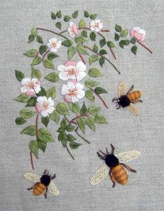 three bees and some flowers on a gray background