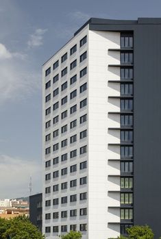 a tall white building with lots of windows