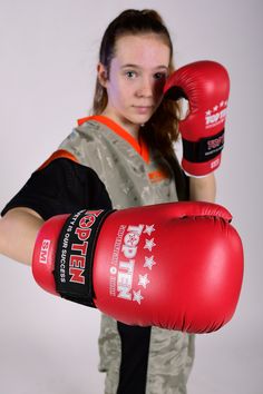 a young woman wearing red boxing gloves