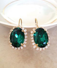 Gorgeous pair of statement size earrings featuring 18x13mm Emerald green oval Swarovski crystals surrounded by a halo of sparkling clear crystals. Green Oval Earrings For Party, Luxury Green Round Bridal Earrings, Green Gold-plated Earrings For Wedding, Elegant Green Jeweled Bridal Earrings, Green Gold-plated Bridal Earrings For Wedding, Green Emerald Drop Crystal Earrings, Green Oval, Halo Earrings, Oval Earring