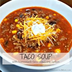 a white bowl filled with taco soup on top of a table