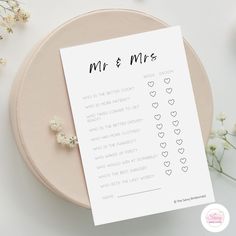 a printable wedding game for mr and mrs on a table next to some baby's breath flowers