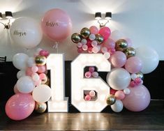 the number sixteen is surrounded by balloons and streamers in pink, white, and gold colors