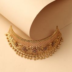 Description This gorgeous yet simple choker set is designed for day events. The Peony Choker from Tarinika Classics is designed with geometric filigree patterns with floral nakshi based on antique gold tone with dangling metal balls. Be it a brunch party or a special event - this will be a perfect partner. Details & Specifications: Materials used: Brass Alloy with Antique Gold Plating Weight – Choker 80.78 gm, Earrings 17 gm Length – Choker 19 cm, Earrings 3.5 cm Make it custom Want to make it a Intricate Design Bridal Choker For Festivals, Festival Bridal Necklace With Intricate Design Choker, Intricate Design Choker For Diwali Celebration, Intricate Design Choker For Diwali, Festive Intricate Design Choker For Celebration, Festive Choker With Intricate Design, Festive Metal Choker For Celebrations, Intricate Design Choker For Festivals, Festive Brass Choker For Festivals