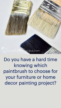 three paintbrushes are sitting next to each other on a white surface, one is silver and the other is black