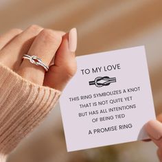 a woman's hand holding a card with a ring on it that says to my love