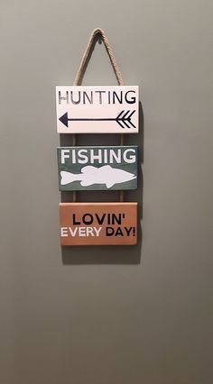 three wooden signs hanging on the wall saying fishing, lovin every day and hunting