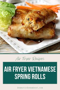 air fryer vietnamese spring rolls on a plate with lettuce and carrots