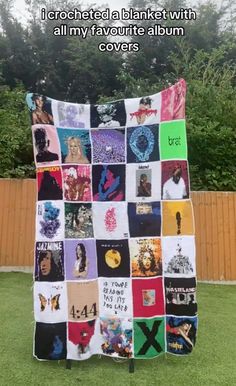 a blanket made out of t - shirts is shown in the grass with words written on it