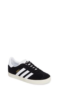 Initially designed as a training shoe for top athletes in 1991, the iconic adidas Gazelle sneaker has been refreshed with a sleek, narrower silhouette but retains the classic 3-Stripes and heel tab of the original. Lace-up style Removable OrthoLite® insole Leather and synthetic upper/textile and synthetic lining/rubber sole Imported Kids' Shoes Black Three Stripes Sneakers For Skateboarding, Adidas Sneakers For Skateboarding, Classic Adidas High-top Sneakers For Sports, Classic Black Adidas Skate Shoes, Classic Black Skate Shoes With Three Stripes, Classic Black Sneakers With Three Stripes, Adidas Tennis Sneakers With White Sole, Black High-top Skate Shoes With Three Stripes, Casual Black Sneakers With Three Stripes