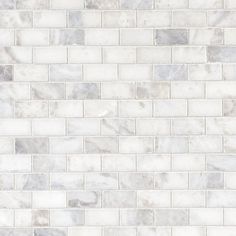 a white brick wall that is made out of marble blocks and has grey veining