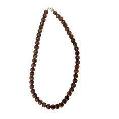 This necklace boasts a clasp closure, showcasing the exquisite natural appearance of Hawaiian Koa Wood, embodied by its 8mm beads. With sizes available in 16, 18, and 20 inches, this popular piece is renowned for its authentic and timeless allure. Material: Koa Wood Bead Size: 8mm Clasp Closing Size: 16 inch | 18 inch | 20 inch Classic Beaded Necklaces With 8mm Round Beads, Brown Single Strand Round Bead Jewelry, Brown Single Strand Necklace With Round Beads, Elegant Single Strand Brown Beads, Brown Necklace With Round Beads And Lobster Clasp, Brown Round Necklace With Lobster Clasp, Formal Brown Necklace With Round Beads, Brown Necklaces With 8mm Round Beads, Classic Single Strand Beads As Gift