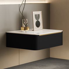 a black and white table with a vase on it next to a framed photo in the corner