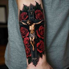 a man with a cross and roses on his arm