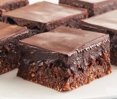 several pieces of chocolate brownie on a white plate