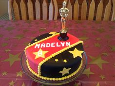 a cake that is on top of a table with stars around it and the name madelyn