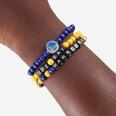 A whole new way to rep the team in style is here. Step up your fan fashion sense with this Golden State Warriors 3 Pack Beaded Friendship Bracelet. These matching friendship bracelets have an all-over team-colored design and team logo displays, which makes them the perfect way to show your support for the Golden State Warriors on gamedays and every day in between. Every bead bracelet design is the perfect addition to your outfit, whether you’re heading to the game, watching at home, or just hang Casual Personalized Beaded Bracelets For Fans, Casual Adjustable Wristband For Fan Merchandise, Casual Game Day Wristband With Letter Beads, Casual Team-colored Beaded Bracelets For Sports Events, Casual Beaded Bracelets In Team Colors For Sports Events, Casual Multicolor Bracelets For Game Day, Casual Blue Jewelry For Game Day, Casual Round Beads Bracelets For Sports Events, Matching Friendship Bracelets