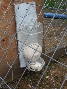 a white toilet sitting in the middle of a fence