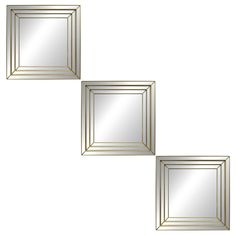 three gold framed mirrors sitting next to each other