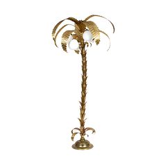 a golden palm tree with three white balls on it's top and two gold leaves