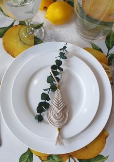 a table setting with lemons and white plates