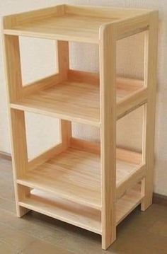 a wooden shelf sitting on top of a hard wood floor