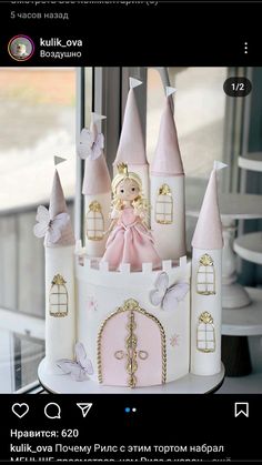 there is a cake that looks like a castle with princess on top and butterflies around it