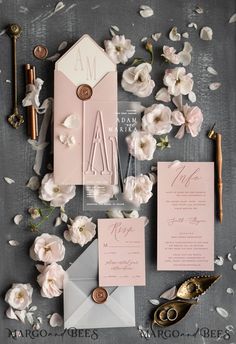 the wedding stationery was done in pink and gray, with white flowers on top