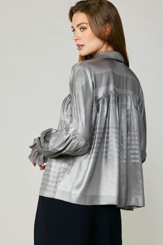 This gently crinkled metallic top instantly dresses up any look. It's got a pointed collar, hidden button placket, and gathered piecing at the bodice and sleeves. Ruffled cuffs add to the wow factor. •Pointed collar •Concealed button placket •Dolman sleeves •Ruffled cuffs with double-button fastening •Gathered piecing at bodice & sleeves •Relaxed fit item number 2330093 100% Polyester Long Sleeve Blouse Designs, Suede Pants, Pleated Shirt, Halloween Sale, Wow Factor, Fashion Updates, Wow Products, We Wear, Dolman Sleeve