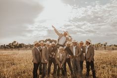 a group of men standing next to each other in a field