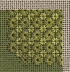 an image of a green and white pattern on burlocked fabric with squares