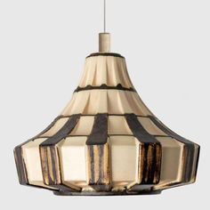 a light fixture with a brown and white striped design on the bottom, hanging from a ceiling