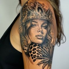 a woman with a crown on her head and feathers around her neck is depicted in this tattoo design