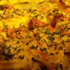 a close up view of some food on a pan with cheese and herbs in it