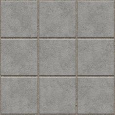 a gray tile wall with several squares in it