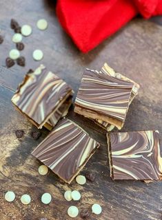 pieces of chocolate candy sitting on top of a wooden table