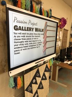 a bulletin board in the middle of a room with writing on it that says passion project gallery walk