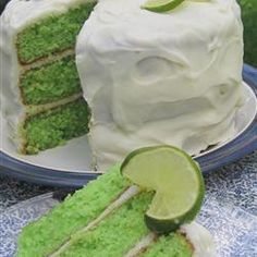 there is a piece of cake with limes on it and the rest of the cake in the background