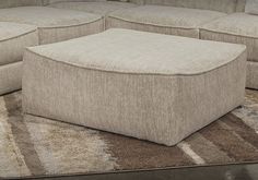 a large beige couch sitting on top of a rug