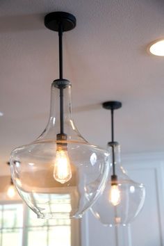 three light bulbs are hanging from the ceiling