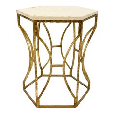 a white marble top side table with gold metal frame and geometric designs on the sides