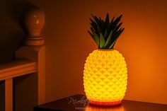 a yellow pineapple lamp sitting on top of a wooden table